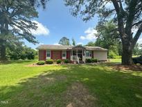 Charming single-story home with red shutters and a well-manicured front lawn at 625 Revell Rd, Selma, NC 27576