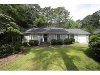 Charming home featuring a well-manicured lawn, tidy landscaping, and a welcoming facade at 6717 Valley Dr, Raleigh, NC 27612