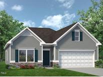 Charming one-story home featuring stone accents, gray siding, a two-car garage, and manicured landscaping at 70 Freedom Heights Ln # 149, Smithfield, NC 27577