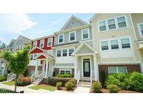 Colorful townhome exterior with well maintained landscaping and inviting entryway at 713 Traditions Grande Blvd, Wake Forest, NC 27587