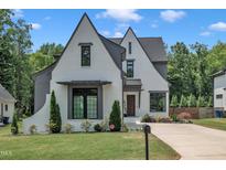 Beautiful home with a well-manicured lawn, classic white painted brick, and a charming architectural style at 800 Wilcox St, Raleigh, NC 27607