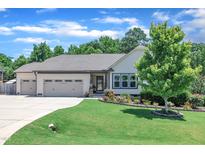 Charming single-story home with a well-manicured lawn, landscaped flowerbeds, and a two-car garage at 85 Willard Wood Run, Benson, NC 27504
