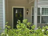 Charming front door adorned with a wreath, offering a welcoming entrance to the home at 916 Woodside Park Ln, Durham, NC 27704