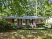 Charming brick home with a well-manicured lawn and inviting front entrance at 926 Wimbleton Dr, Raleigh, NC 27609