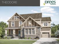 A lovely two-story home with a stone and siding exterior, complemented by a neatly landscaped front yard at Tbd Lot 11 Montgomery Estates Rd, Hillsborough, NC 27278