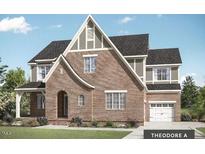 Charming two-story home with brick exterior, arched entryway, and attached two-car garage at Tbd Lot 11 Montgomery Estates Rd, Hillsborough, NC 27278