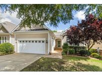 Charming home exterior featuring a two-car garage and well-maintained landscaping at 1034 Ventnor Pl, Cary, NC 27519