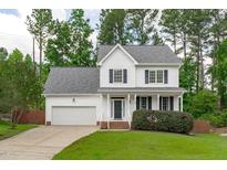 Charming two-story home featuring a well-manicured lawn and an attached two-car garage at 1111 Barrow Nook Ct, Apex, NC 27502