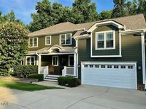 Charming two-story home with a two car garage and inviting curb appeal and mature trees in the background at 1113 Bexley Hills Bend Bnd, Apex, NC 27502