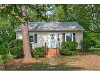 Charming single-story home with light siding, brick foundation and well-maintained landscaping at 1209 Edgevale Rd, Durham, NC 27701