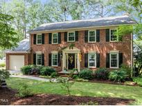 Charming two-story brick home with black shutters and a well-manicured front yard at 1304 Sandpiper Ct, Raleigh, NC 27615