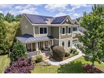 Inviting two-story home with solar panels, front porch, and landscaped front yard at 1504 Hemlock Hill Dr, Durham, NC 27703