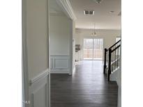 Inviting hallway leading to the living spaces, enhanced by hardwood floors and stylish wall trim at 185 Bourne Dr, Franklinton, NC 27525