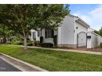 Charming single-story home with white siding, mature trees, and well-maintained landscaping at 23 Caldwell, Pittsboro, NC 27312