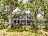 Charming home nestled in a lush landscape with a welcoming front porch and beautiful curb appeal at 2400 Fairview Rd, Raleigh, NC 27608