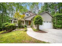 Charming home with a well-maintained front yard, mature trees, and an attached two-car garage at 2612 Scarlet Sage Ct, Raleigh, NC 27613
