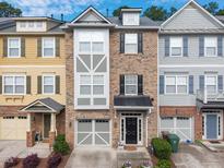 Beautiful townhome featuring a symmetrical elevation, driveway, manicured lawn and neutral color palette at 276 Linden Park Ln, Cary, NC 27519