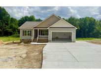 Charming single-story home with a two-car garage and covered porch, in a wooded area at 2760 Rains Mill Rd, Princeton, NC 27569