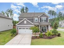 Charming two-story home with a manicured front yard and a two-car garage with stone accents at 3361 Bordwell Ridge Dr. Dr, New Hill, NC 27562