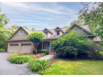 Charming brick home with a three-car garage, well-manicured lawn, and mature trees at 3600 Trail 23 St, Durham, NC 27707