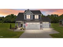 Charming two-story home with a spacious driveway, two-car garage, and covered front porch at 385 Jackson Pond Dr, Smithfield, NC 27577