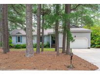 Charming single-story home with a well-maintained lawn, light grey siding, and a two-car garage surrounded by mature trees at 502 Hillcrest Rd, Apex, NC 27502