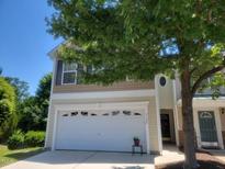 Two-story home featuring a two-car garage and a well-maintained lawn at 5126 Thornton Knoll Way, Raleigh, NC 27616
