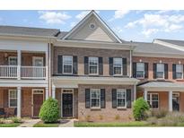 Charming brick townhome featuring a classic design and well-maintained landscaping at 513 Dragby Ln, Raleigh, NC 27603