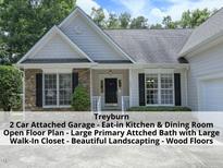 Charming single-story home with stone accents, black shutters, and inviting front porch at 603 Red Cedar Cir, Durham, NC 27712