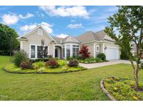 Charming single-story home featuring well-manicured landscaping and a two-car garage at 610 Mixboro Dr, Cary, NC 27519