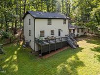 Charming home featuring a spacious back deck ideal for outdoor gatherings and overlooking the serene wooded lot at 6817 Guess Rd, Hillsborough, NC 27278