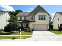 Charming two-story home with a well-manicured lawn, driveway, and an attached garage at 825 Fulworth Ave, Wake Forest, NC 27587