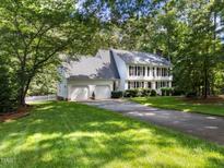 Beautiful two-story home with a well-manicured lawn, a two car garage and mature trees at 8909 Wellsley Way, Raleigh, NC 27613