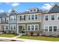 Inviting townhome featuring a stone foundation, neutral siding and a well-maintained lawn at 937 Baldwin Ridge Rd, Apex, NC 27523