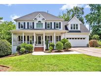 Charming two-story home with a welcoming front porch and well-manicured landscaping at 100 Highfield Ave, Cary, NC 27519
