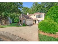 Charming two-story home featuring a brick and siding exterior, attached garage, and a lush landscaped yard at 105 Walter Hagen Dr, Mebane, NC 27302