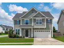 Charming two-story home featuring a manicured lawn and a two-car garage at 1214 Valley Dale Dr, Fuquay Varina, NC 27526