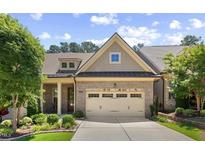 Charming brick home showcasing a well-manicured lawn and attached two car garage at 122 Glenpark Pl, Cary, NC 27511