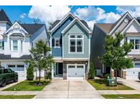 Charming two-story home with stone accents, an attached garage, and a well-manicured lawn at 1363 Brown Velvet Ln, Apex, NC 27523