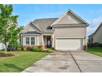 Charming home with a well-manicured lawn and attached two car garage at 1409 Sage Tree Dr, Zebulon, NC 27597