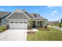 Charming single-Gathering home with a two-car garage, manicured lawn and inviting front porch at 1633 Hillstar St, Fuquay Varina, NC 27526