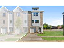Charming new construction townhome featuring a brick and siding facade and an attached one car garage at 1921 Fishamble St # 13, Fuquay Varina, NC 27526