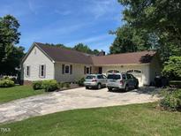 Charming single-story home features a two-car garage, neutral siding, and a well-maintained lawn at 2257 Delaney Dr, Burlington, NC 27215