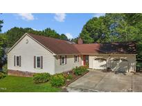 Charming ranch home featuring a two-car garage, well-maintained lawn, and tasteful landscaping at 2257 Delaney Dr, Burlington, NC 27215