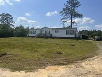 Charming single-story home with white siding and a spacious front yard on a sunny day at 248-A Gilbert Rd, Benson, NC 27504