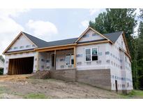 New construction home with a brick foundation and attached two-car garage, awaiting personalization at 299 Little Lady Trail, Zebulon, NC 27597