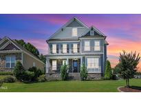 Charming two-story home with stone accents, manicured lawn, and inviting front porch at 503 Bendemeer Ln, Rolesville, NC 27571
