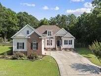 Charming two-story home with landscaped yard and a long driveway at 55 Kristopher Woods Dr, Youngsville, NC 27596