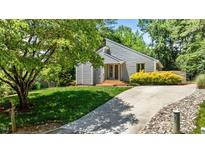 Charming home showcasing a well-manicured lawn and concrete driveway leading up to the front entrance and a tree at 7309 Forest Glade Ct, Raleigh, NC 27615