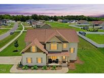 Inviting two-story home with a charming front porch and well-manicured lawn at 81 Olive Branch Dr, Smithfield, NC 27577